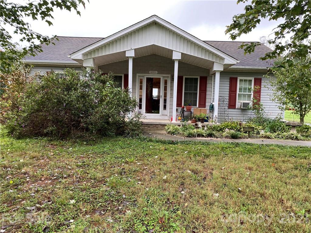 1033 Tabor Road Olin, NC 28660 - Photo 1 of 14 front view of a house with a yard
