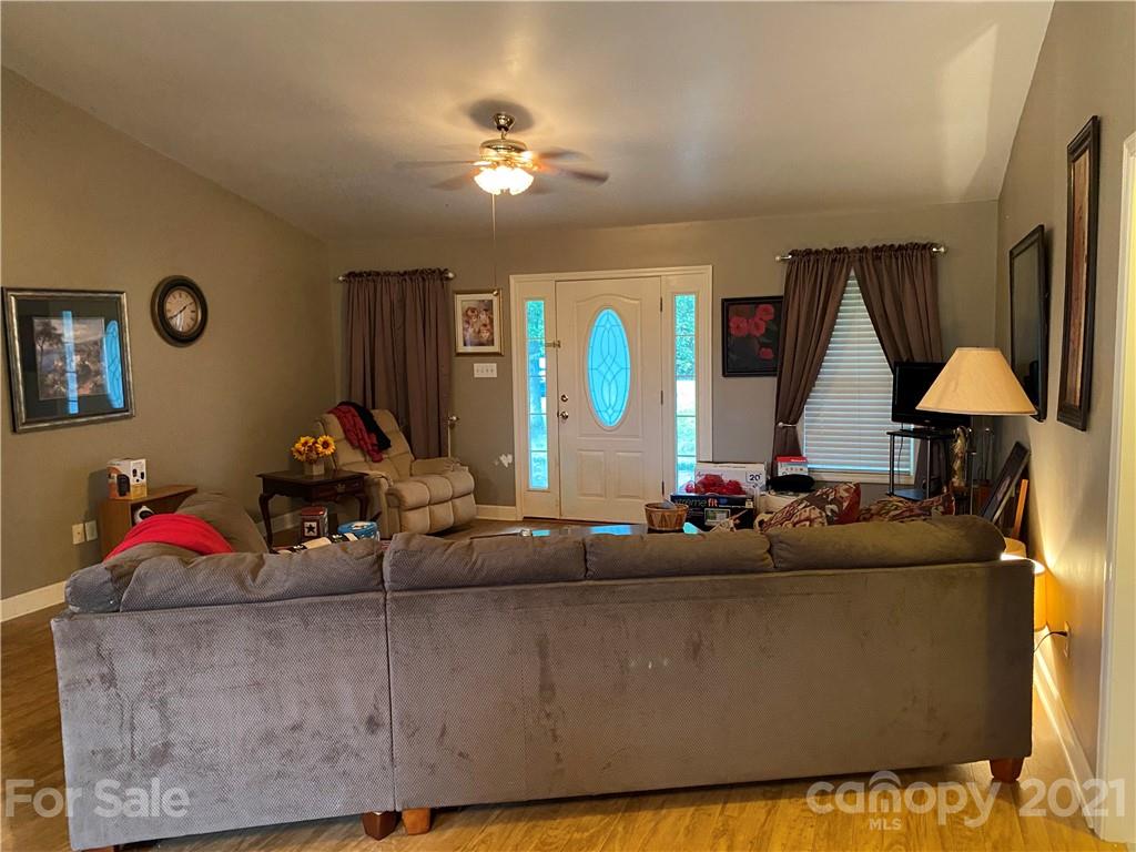 1033 Tabor Road Olin, NC 28660 - Photo 2 of 14 a living room with furniture and a chandelier