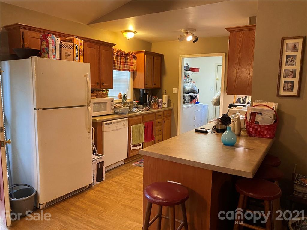 1033 Tabor Road Olin, NC 28660 - Photo 3 of 14 a kitchen with stainless steel appliances a stove a refrigerator and a dining table