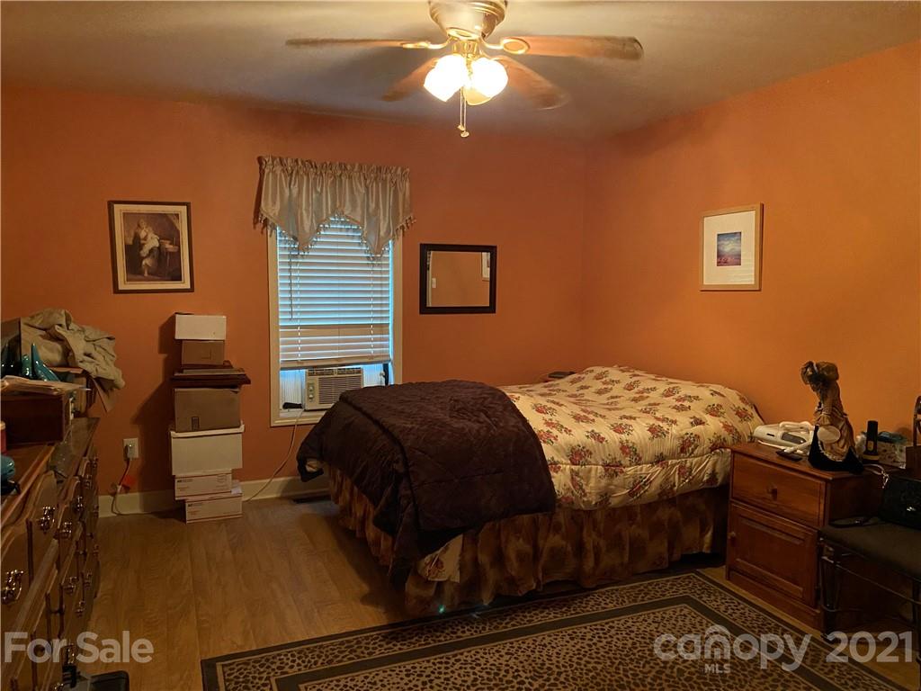 1033 Tabor Road Olin, NC 28660 - Photo 4 of 14 a bedroom with a bed and a chandelier