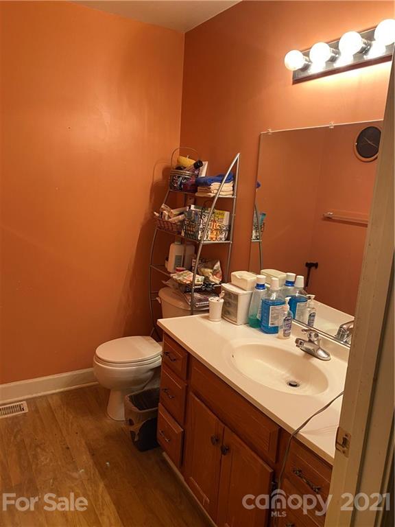 1033 Tabor Road Olin, NC 28660 - Photo 6 of 14 a bathroom with a sink a toilet and mirror