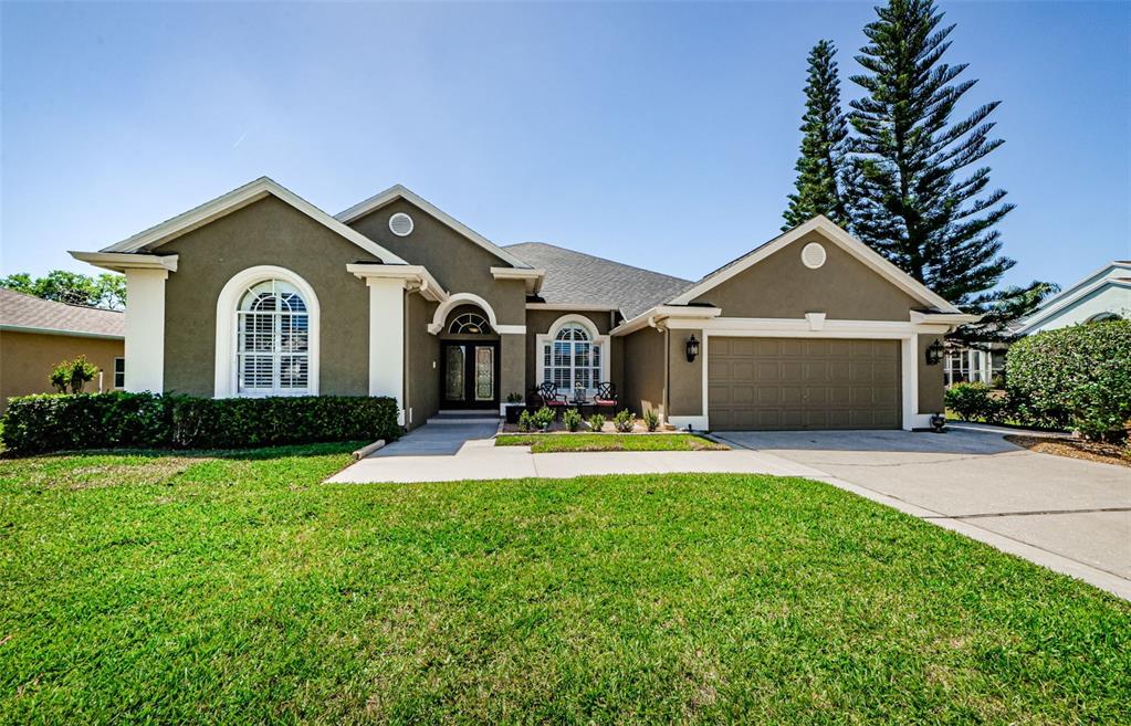 a front view of a house with a yard and garage