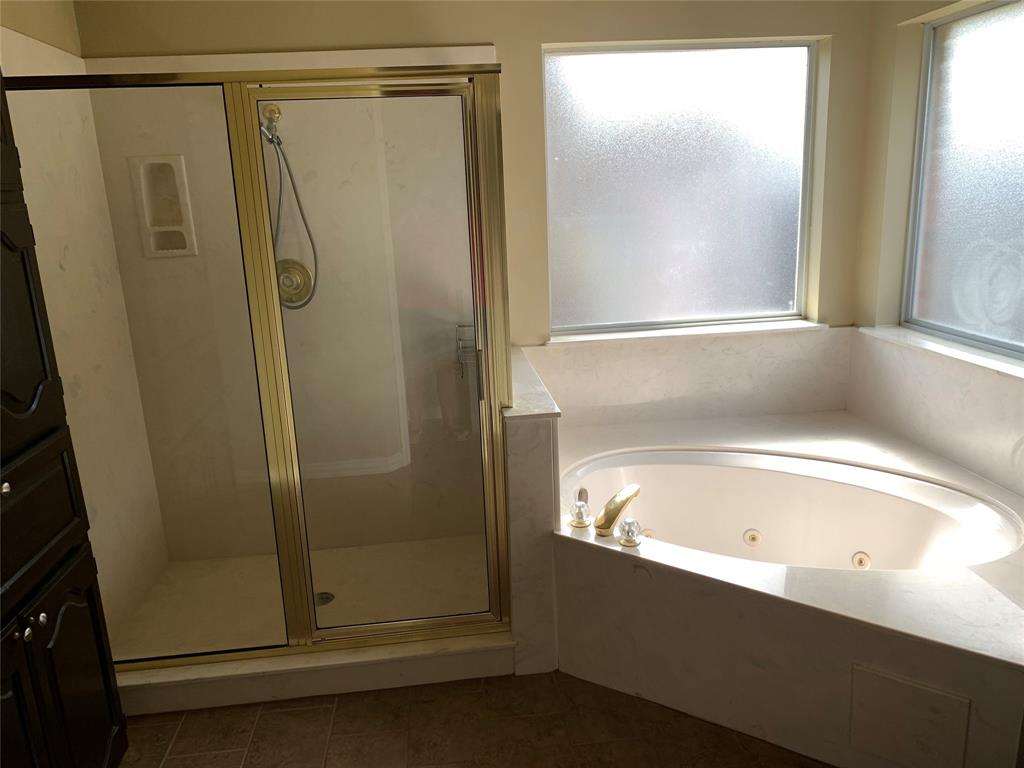 4914 Shadowood Road Colleyville, TX 76034 - Photo 11 of 28 Full bathroom with healthy amount of natural light, a stall shower, a whirlpool tub, and tile patterned floors