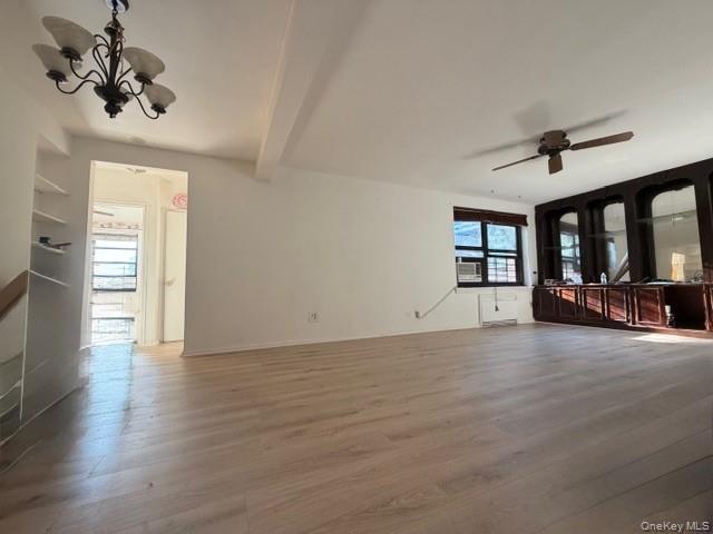 75-08 Bell Boulevard, Unit 2J Queens, NY 11364 - Photo 11 of 23 a view of an empty room with a window and wooden floor
