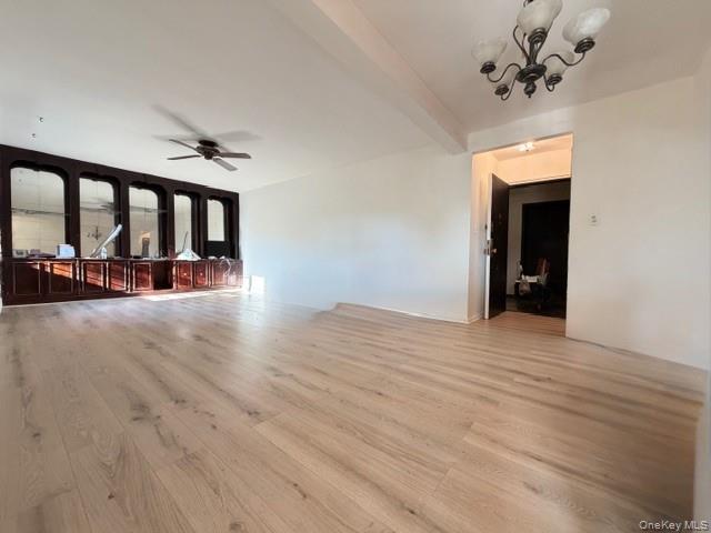 75-08 Bell Boulevard, Unit 2J Queens, NY 11364 - Photo 2 of 23 a view of a room with wooden floor and a ceiling fan
