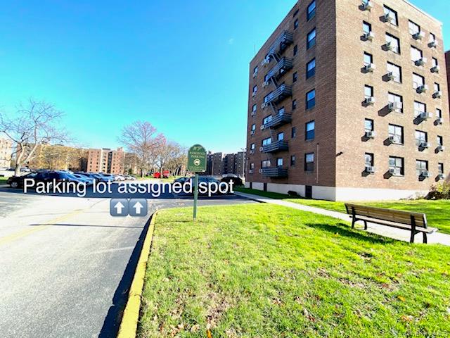 75-08 Bell Boulevard, Unit 2J Queens, NY 11364 - Photo 21 of 23 a swimming pool with outdoor seating and yard
