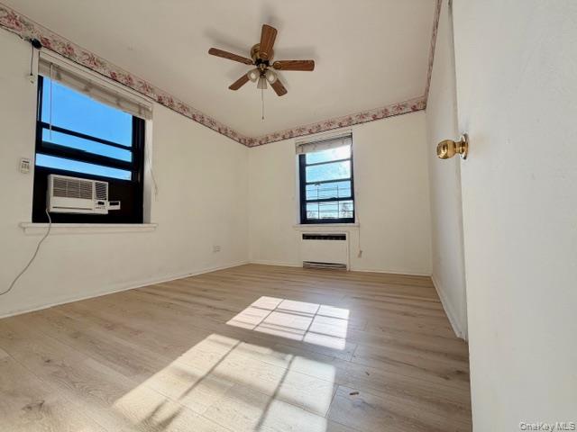 75-08 Bell Boulevard, Unit 2J Queens, NY 11364 - Photo 6 of 23 a view of a livingroom with a ceiling fan and window