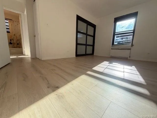 wooden floor in an empty room with a window