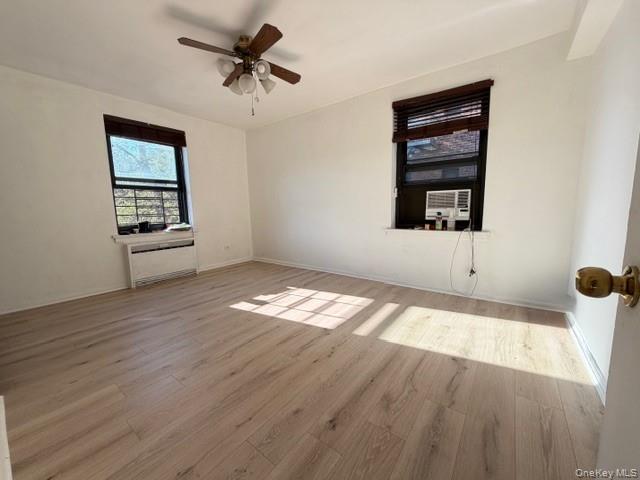 75-08 Bell Boulevard, Unit 2J Queens, NY 11364 - Photo 10 of 23 wooden floor in an empty room with a window