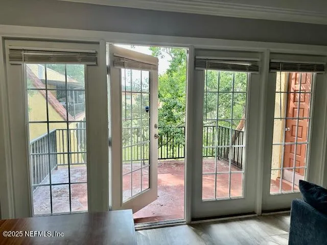 a view of hallway with furniture and floor to ceiling window