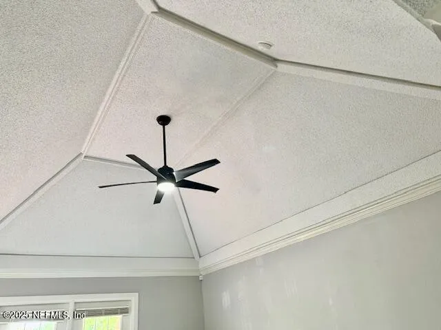 a view of a room with a ceiling fan