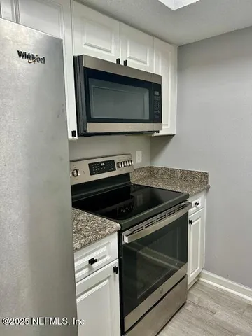 a kitchen with a stove and a microwave