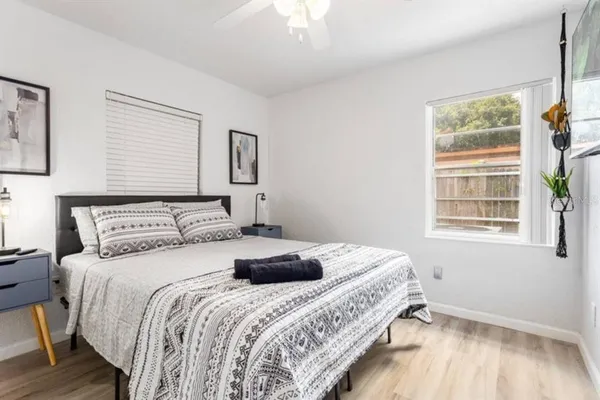 a bedroom with a bed and a window