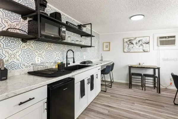 a kitchen with stainless steel appliances a sink and cabinets