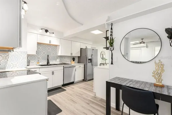 a kitchen with granite countertop a sink cabinets and outdoor space
