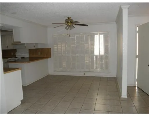 a view of a kitchen with an empty space and a window