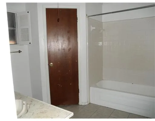 a bathroom with a bathtub and shower