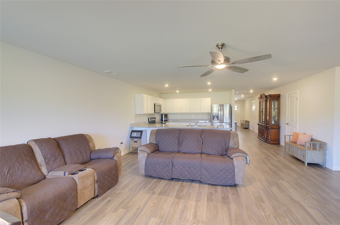408 Chadwick Lane Walhalla, SC 29691 - Photo 43 of 44 An open floorplan seamlessly connects the living area to a modern kitchen, featuring recessed lighting and durable laminate flooring throughout.