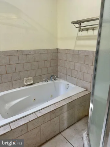 a bathroom with a bathtub and shower