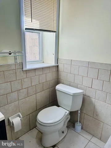 a white toilet sitting next to a bathroom sink