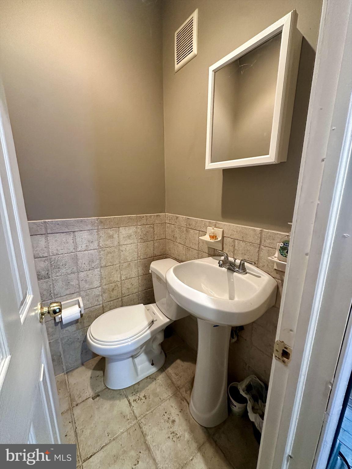 3918 Brandywine Street Philadelphia, PA 19104 - Photo 6 of 18 a bathroom with a sink toilet and a mirror