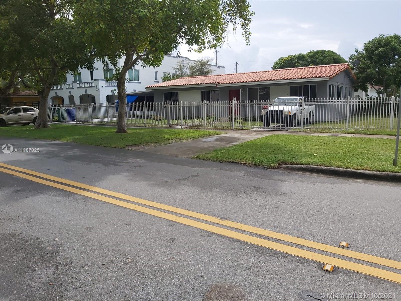 1000 Southwest 23rd Avenue Miami, FL 33135 - Photo 2 of 2 a front view of a house with a yard table and chairs