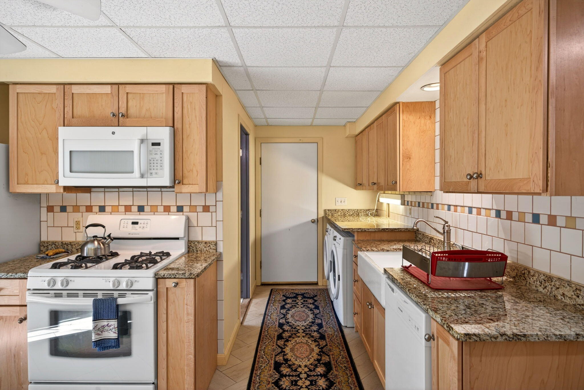 73 County Road Bourne, MA 02532 - Photo 69 of 91 a kitchen with stainless steel appliances granite countertop a sink stove and refrigerator