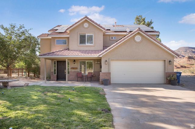 1440 West 100 South Virgin, UT 84779 - Photo 4 of 45 Stucco exterior with a tiled roof and integrated solar panels