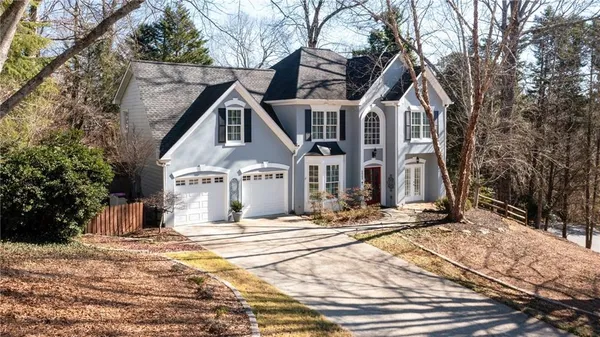 a view of a house with snow on the road