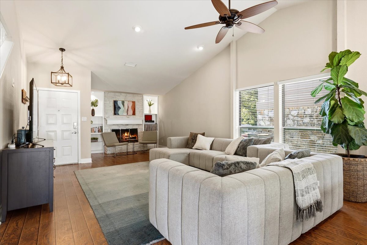 12400 Rusted Nail Cove Austin, TX 78750 - Photo 4 of 31 Vaulted ceilings and expansive windows fill the living room with natural light.