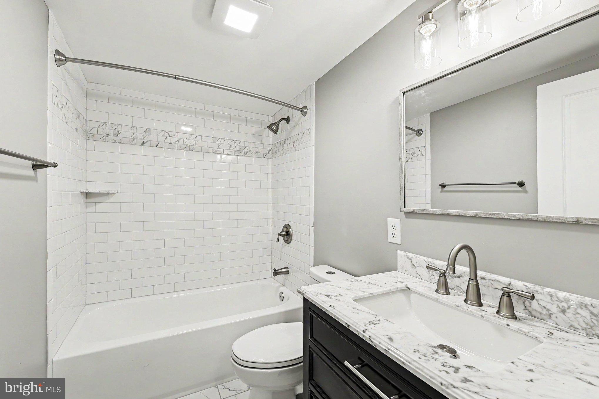 9135 Cuckold Point Road Sparrows Point, MD 21219 - Photo 23 of 44 a bathroom with a granite countertop sink toilet and shower