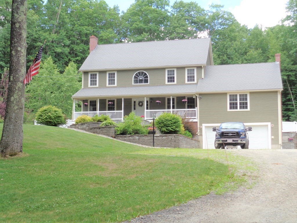 a aerial view of a house with a yard and sitting area