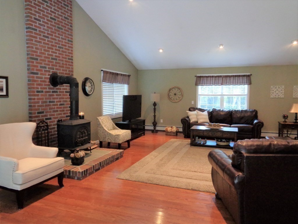 7 R Oxbow Road Oxford, MA 01537 - Photo 17 of 40 a living room with furniture a flat screen tv and a window