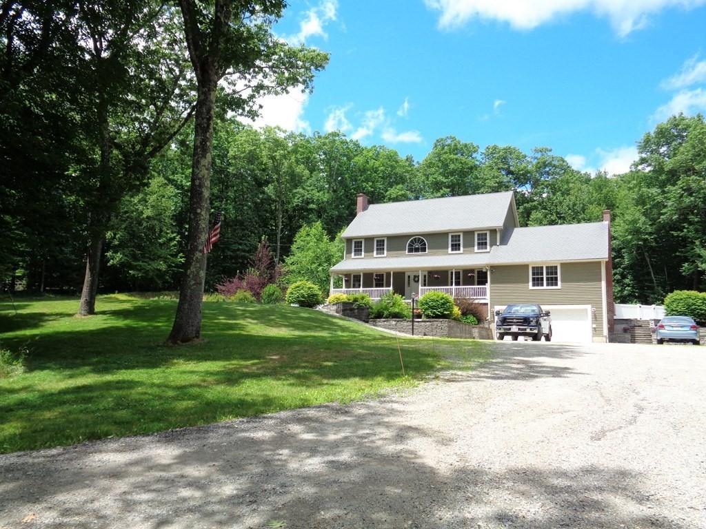 7 R Oxbow Road Oxford, MA 01537 - Photo 2 of 40 a front view of a house with a yard porch and sitting area