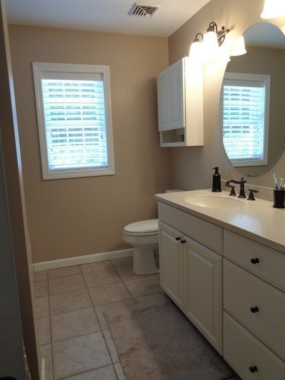 7 R Oxbow Road Oxford, MA 01537 - Photo 28 of 40 a bathroom with a toilet sink and mirror