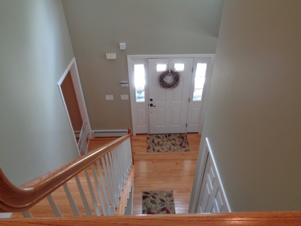 7 R Oxbow Road Oxford, MA 01537 - Photo 6 of 40 a view of a hallway with wooden floor and staircase