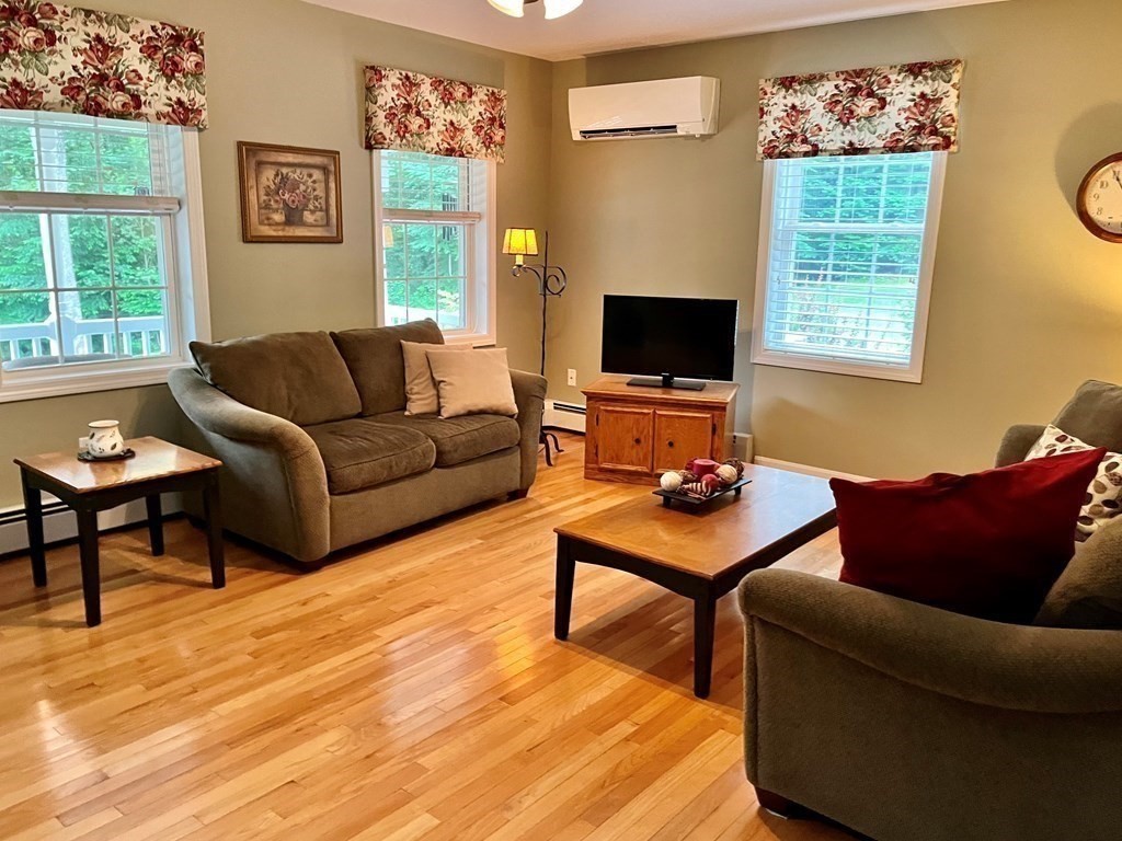 7 R Oxbow Road Oxford, MA 01537 - Photo 9 of 40 a living room with furniture a flat screen tv and a window