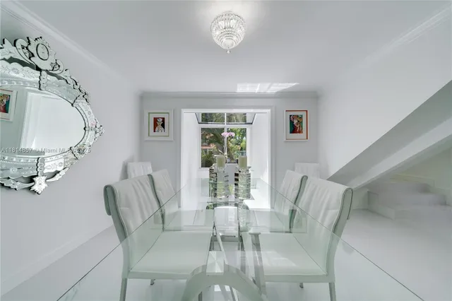 a living room with furniture a window and a flat screen tv