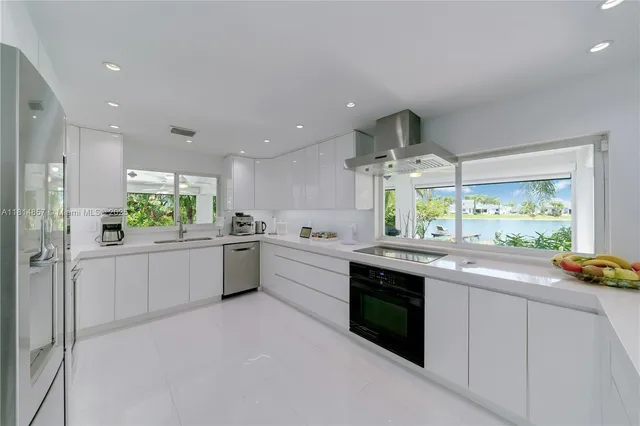 a living room with furniture flat screen tv and a large window