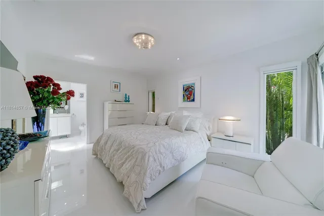 a living room with patio furniture and a large window