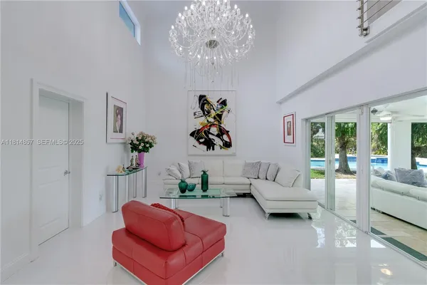 a living room with furniture and a chandelier