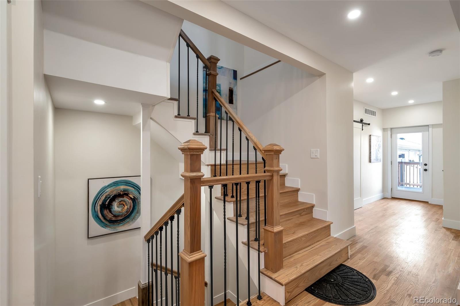 1417 Monroe Street Denver, CO 80206 - Photo 18 of 43 a view of entryway and hall with wooden floor