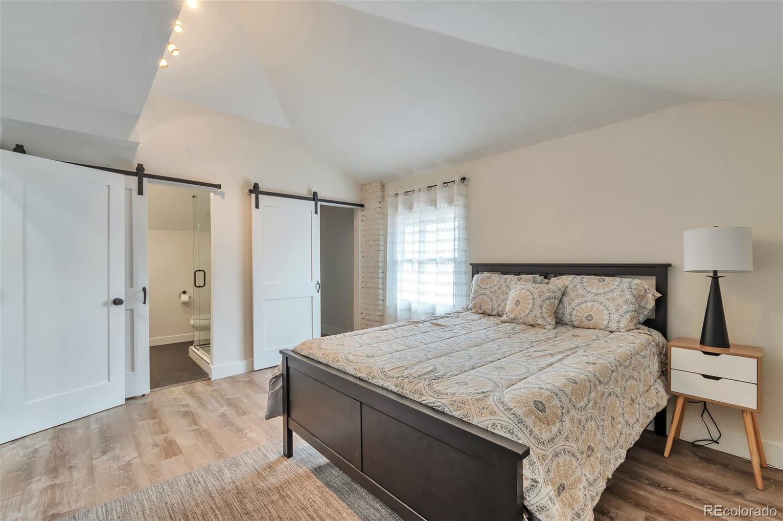 1417 Monroe Street Denver, CO 80206 - Photo 28 of 43 a bedroom with a bed and a window