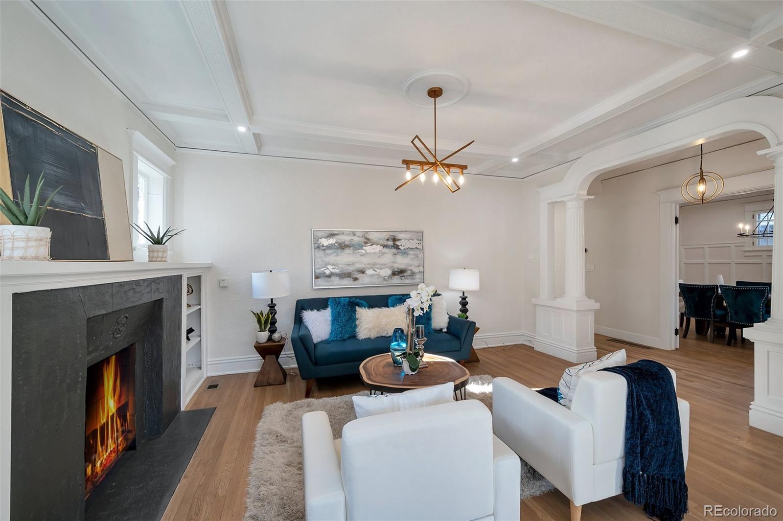 1417 Monroe Street Denver, CO 80206 - Photo 39 of 43 a living room with furniture a fireplace and a flat screen tv