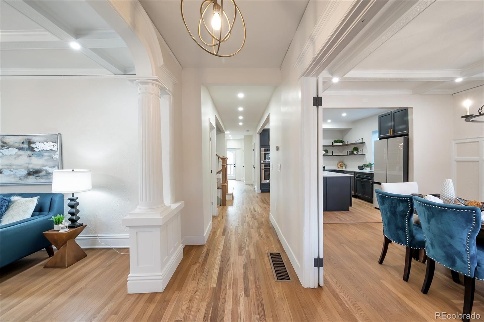 1417 Monroe Street Denver, CO 80206 - Photo 4 of 43 a view of a dining room with furniture a potted plant and wooden floor