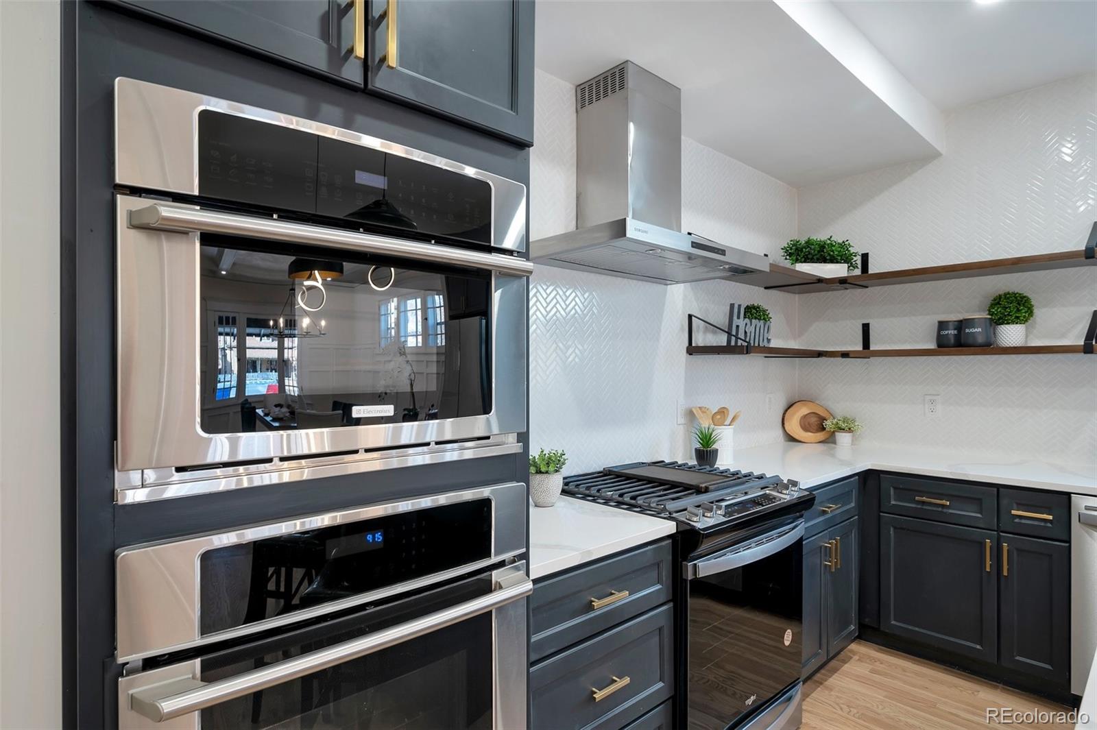 1417 Monroe Street Denver, CO 80206 - Photo 9 of 43 a kitchen with stainless steel appliances granite countertop a stove and a microwave