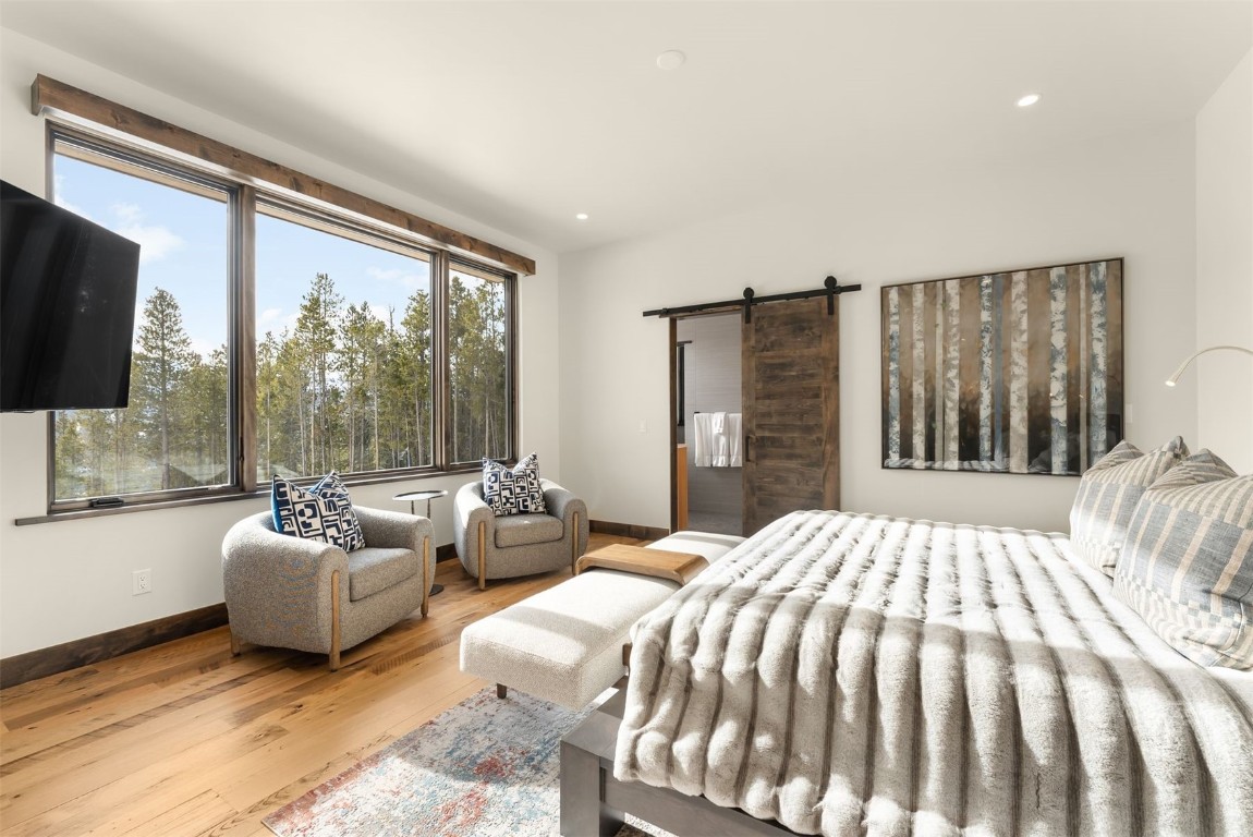 67 Marys Ridge Lane Breckenridge, CO 80424 - Photo 20 of 35 a bedroom with a bed and glass door