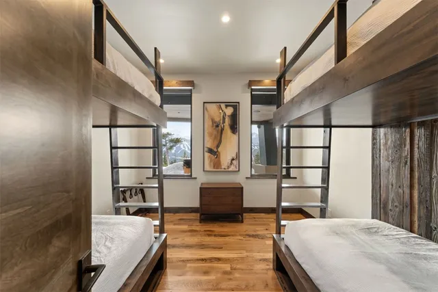 a bedroom with furniture and wooden floor