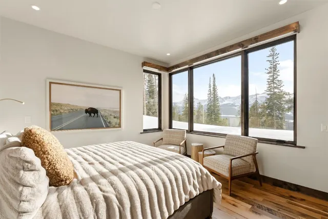 a bedroom with a bed and a painting on the wall