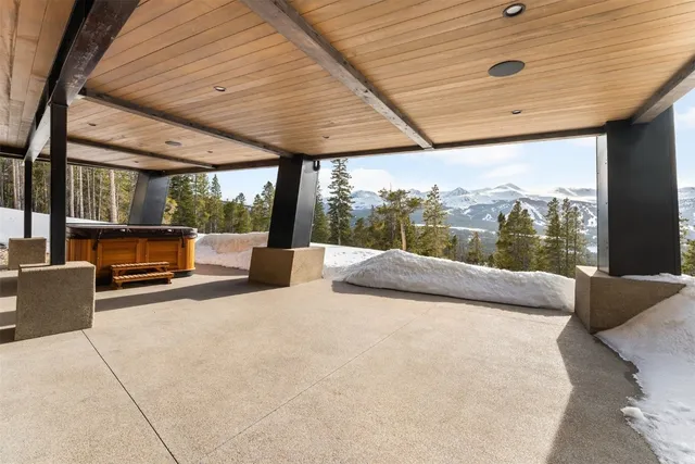 a bedroom with furniture and large windows